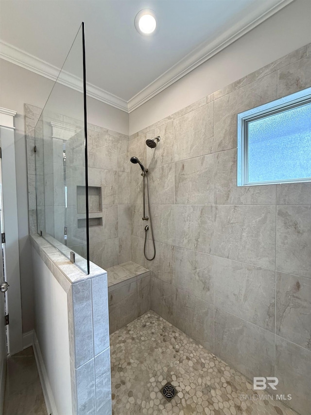 bathroom with crown molding and walk in shower