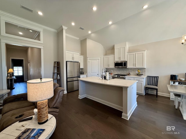 kitchen featuring appliances with stainless steel finishes, white cabinets, light countertops, and visible vents