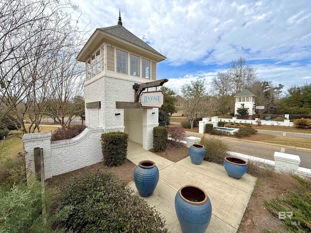 view of property exterior featuring brick siding and roof with shingles