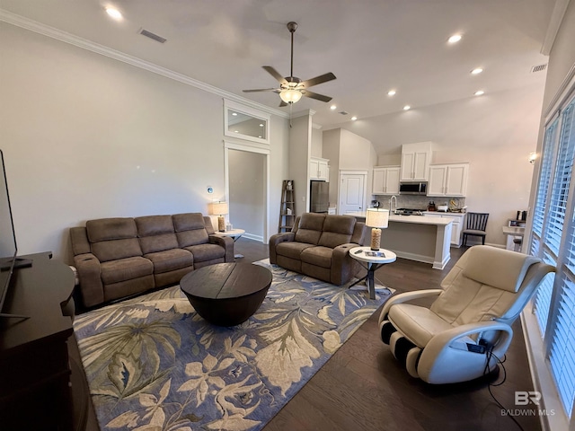 living area featuring crown molding, recessed lighting, visible vents, dark wood-type flooring, and a ceiling fan