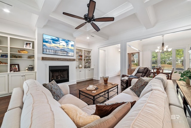 living room with built in features, coffered ceiling, beamed ceiling, and dark wood-type flooring