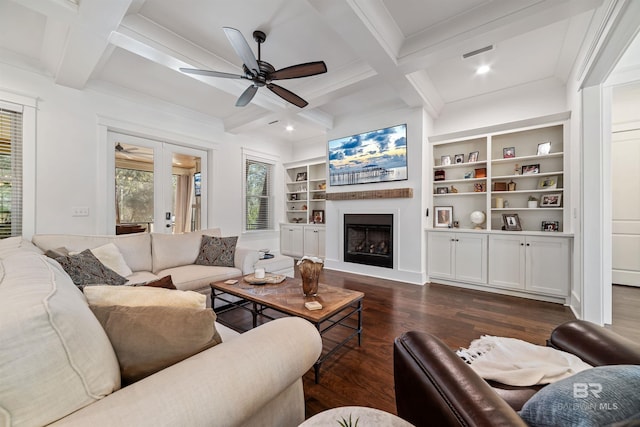 living room featuring dark wood-type flooring, built in shelves, french doors, ceiling fan, and beam ceiling