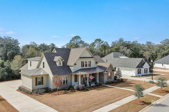 modern inspired farmhouse featuring a garage and a porch