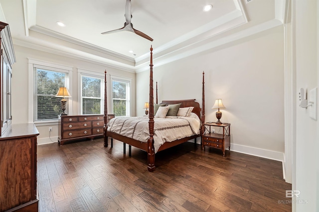 bedroom with ceiling fan, crown molding, dark hardwood / wood-style flooring, and a tray ceiling