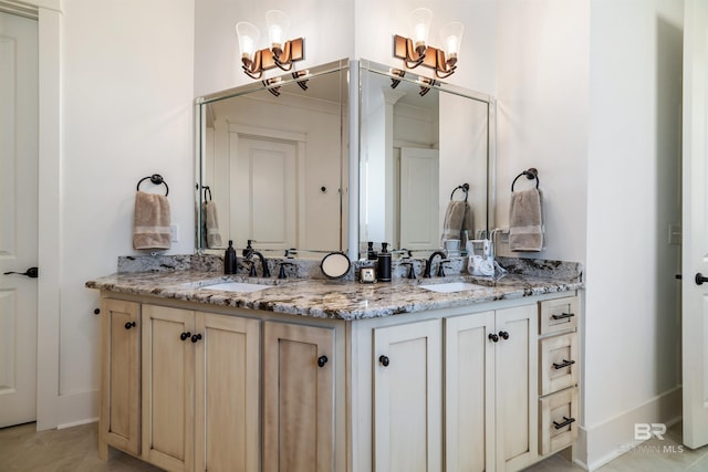 bathroom featuring an inviting chandelier, tile patterned floors, and vanity