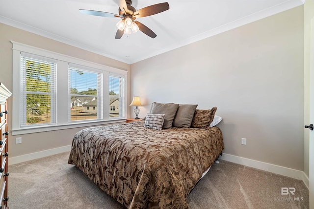 carpeted bedroom featuring ceiling fan and ornamental molding