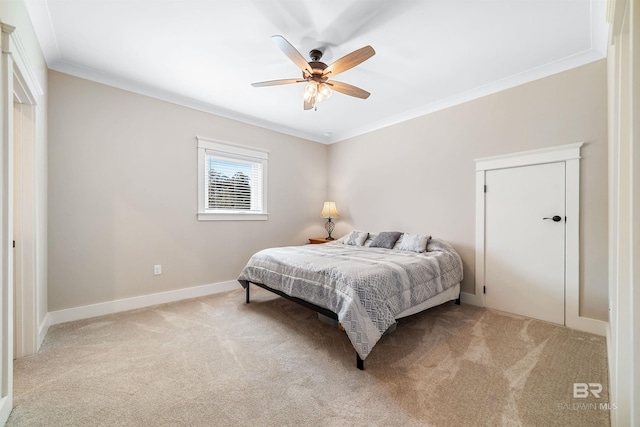 bedroom with ornamental molding, ceiling fan, and light colored carpet