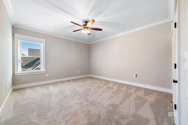 spare room with light carpet, ceiling fan, and crown molding