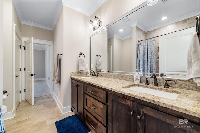 bathroom with curtained shower, vanity, and crown molding