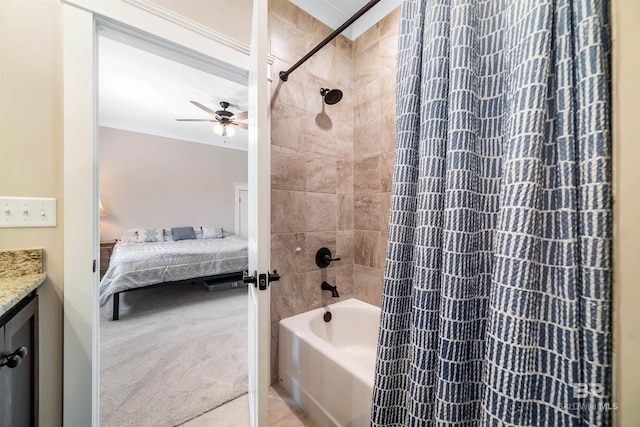 bathroom with vanity, ceiling fan, tiled shower / bath, and crown molding