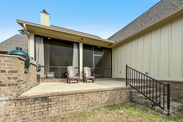 back of house with a patio area and a sunroom