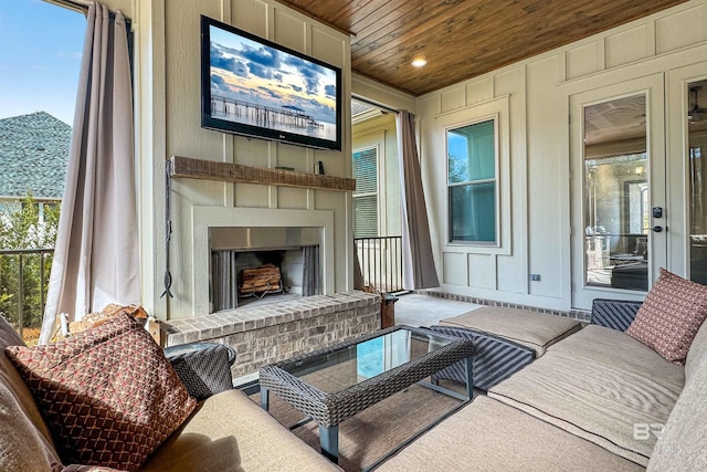 sunroom / solarium with wooden ceiling, a wealth of natural light, and a fireplace