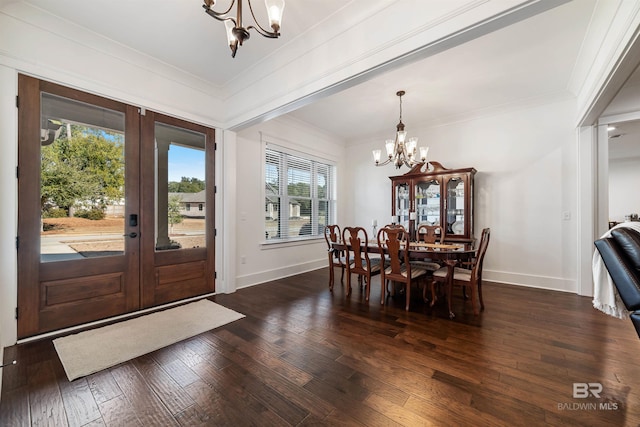 dining room with french doors, a chandelier, ornamental molding, and dark hardwood / wood-style floors