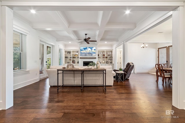 living room with ceiling fan with notable chandelier, dark hardwood / wood-style flooring, beamed ceiling, and coffered ceiling