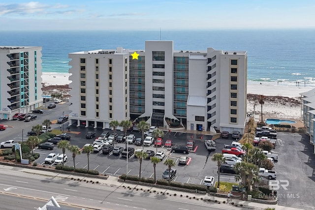 view of property featuring a view of the beach and a water view