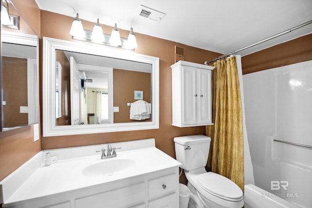 bathroom with visible vents, curtained shower, toilet, and vanity