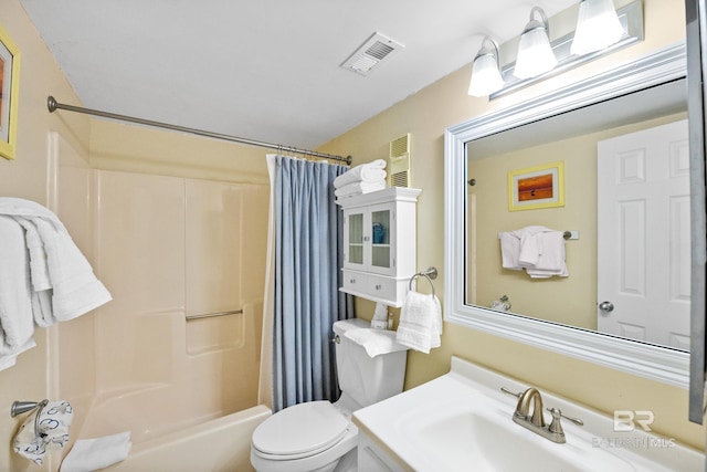 bathroom featuring visible vents, toilet, shower / tub combo, and a sink