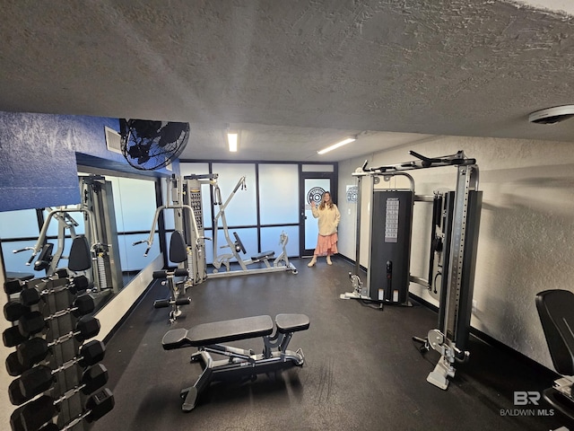 gym featuring a textured ceiling