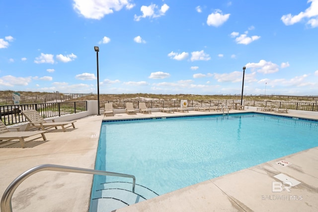 pool featuring a patio and fence