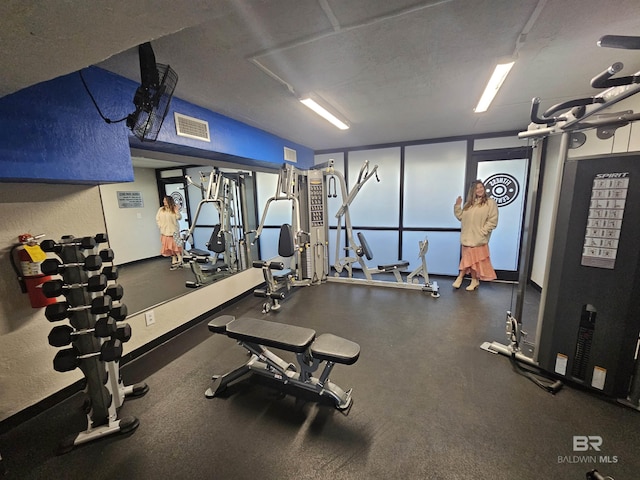 exercise room with visible vents and a textured ceiling