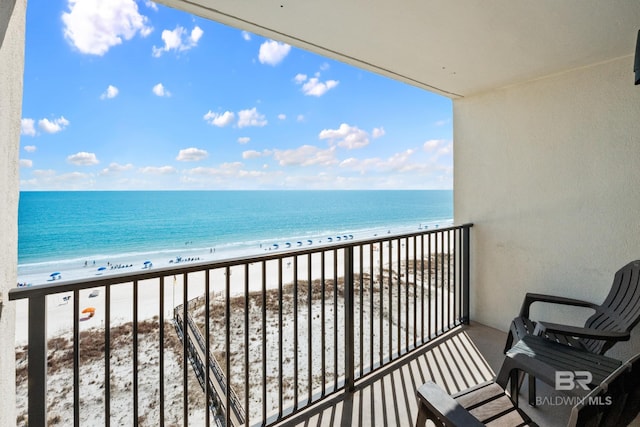 balcony with a beach view and a water view