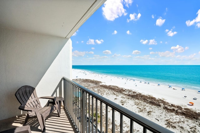 balcony featuring a water view and a view of the beach