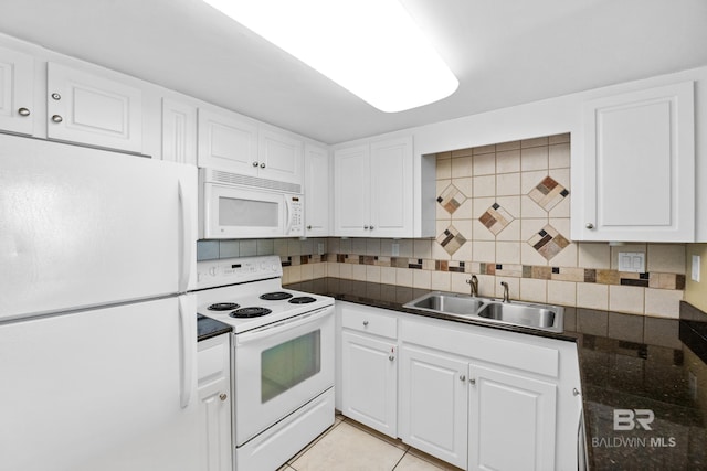 kitchen featuring decorative backsplash, white appliances, white cabinetry, and a sink