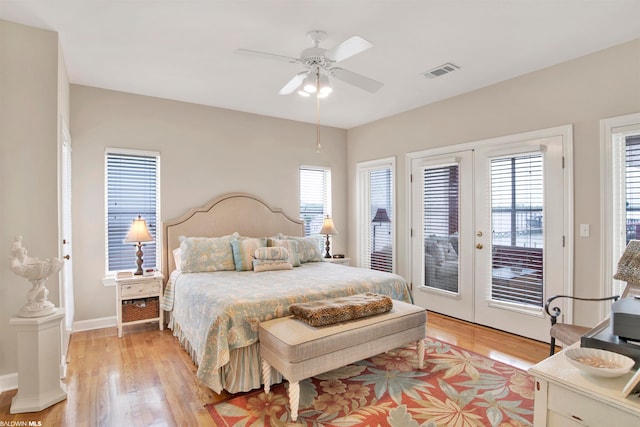 bedroom featuring ceiling fan, light hardwood / wood-style flooring, french doors, and access to outside