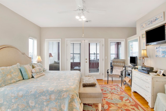 bedroom featuring multiple windows, ceiling fan, access to outside, and light hardwood / wood-style flooring