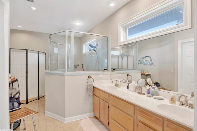 bathroom featuring an enclosed shower, double sink, tile floors, and large vanity