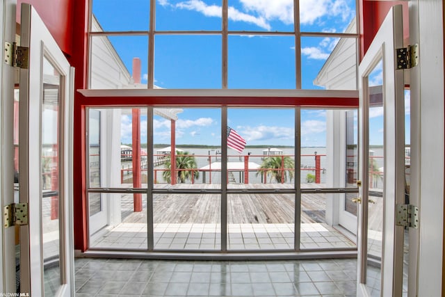 doorway featuring french doors, a healthy amount of sunlight, and light tile floors