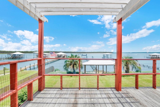 balcony with a water view and a pergola