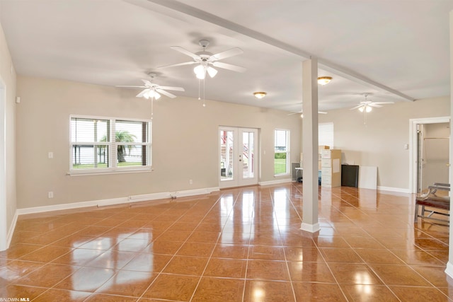 unfurnished living room with french doors, a healthy amount of sunlight, light tile floors, and ceiling fan