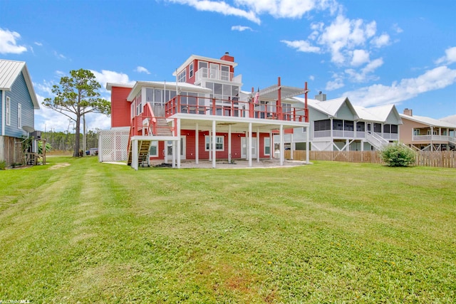 rear view of house with a yard and a patio