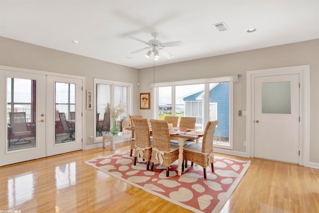 dining space with french doors, ceiling fan, and light hardwood / wood-style flooring