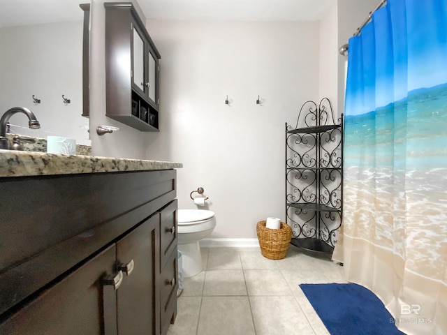 bathroom featuring tile patterned floors, vanity, and toilet