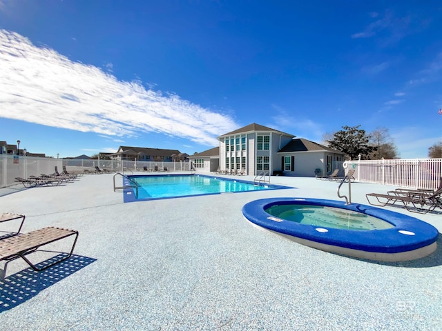 view of swimming pool featuring a community hot tub and a patio area