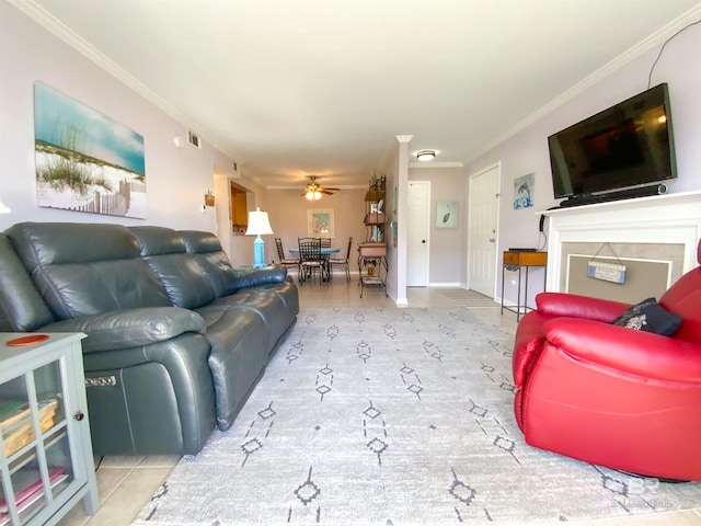 living room featuring ceiling fan and crown molding