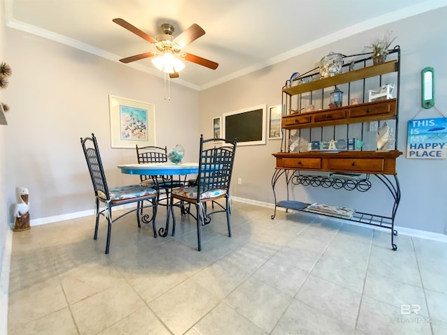 tiled dining area featuring ornamental molding and ceiling fan