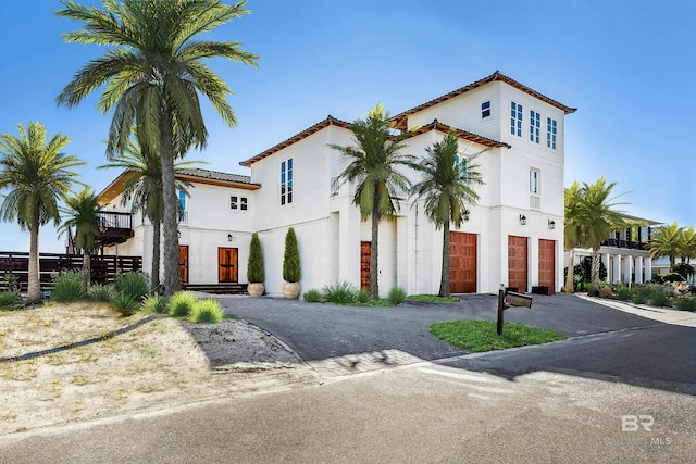 mediterranean / spanish-style house with a garage