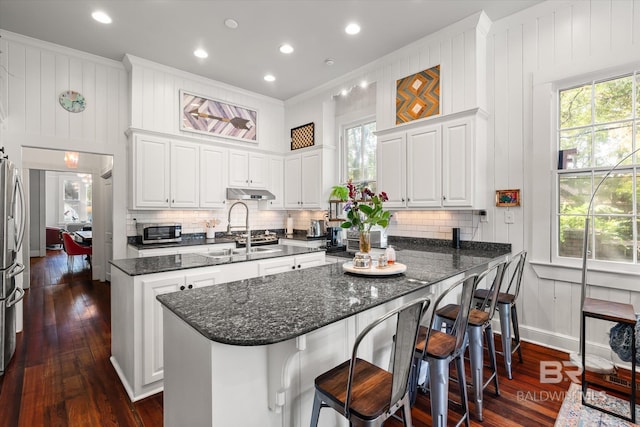 kitchen featuring dark hardwood / wood-style flooring, white cabinetry, appliances with stainless steel finishes, and sink