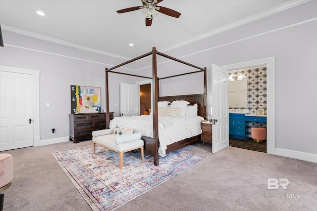 carpeted bedroom featuring ornamental molding, ensuite bath, and ceiling fan