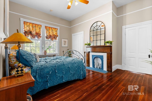 bedroom featuring ceiling fan, dark hardwood / wood-style floors, and a closet