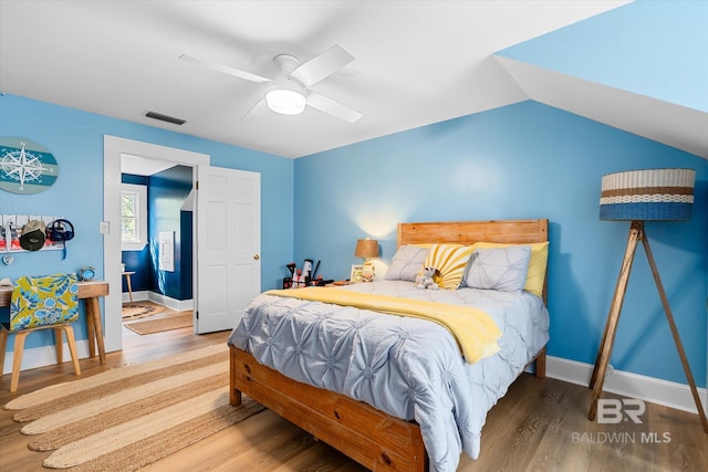 bedroom with lofted ceiling, wood-type flooring, and ceiling fan