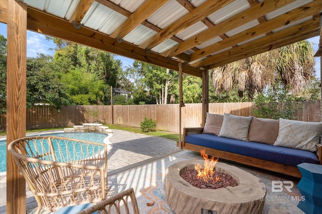 view of patio / terrace featuring an outdoor fire pit and a fenced in pool