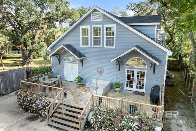 back of property with a wooden deck, french doors, and an outdoor hangout area