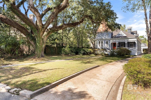 exterior space featuring a porch and a front lawn