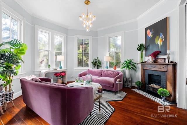 living room featuring dark wood-type flooring, a chandelier, ornamental molding, and a brick fireplace