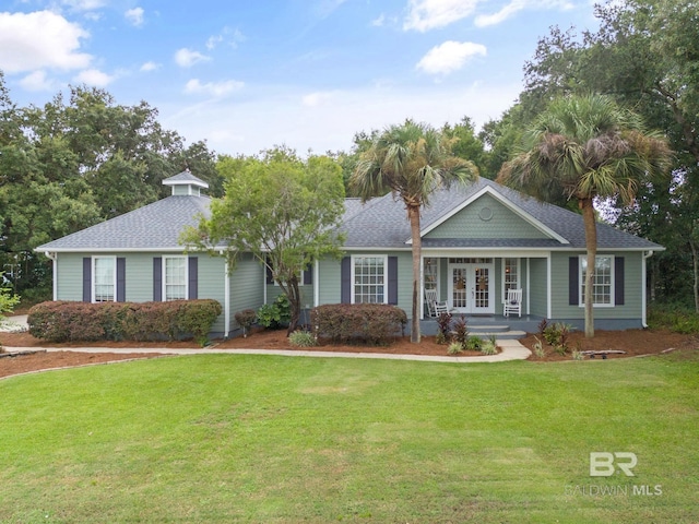 ranch-style home featuring a front lawn and a porch