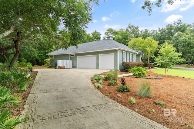 view of side of home featuring a lawn and a garage